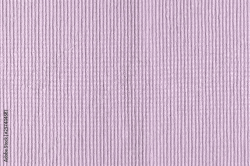 Sofa upholstery close-up. Texture of rough dense ribbed fabric. Lilac blank background for layouts.