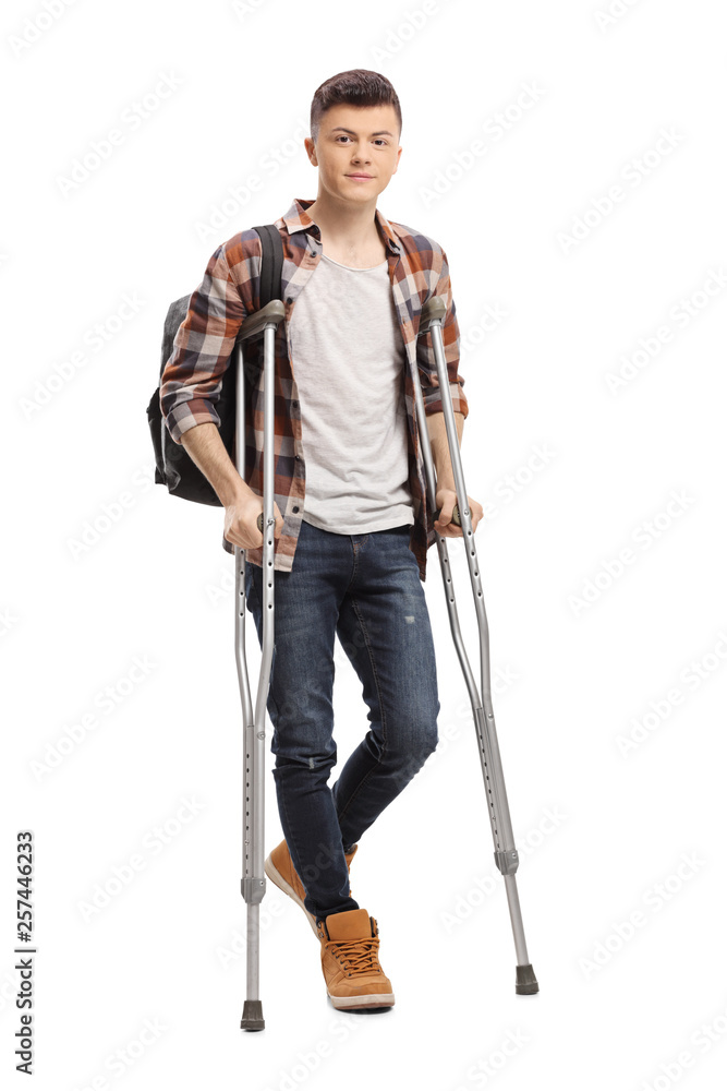 Male student walking with crutches Male student walking with crutches