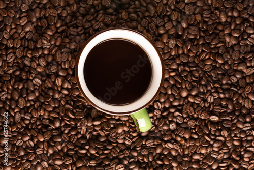 coffee mug with coffee on coffee bean texture