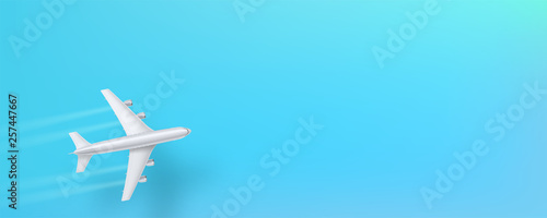 Silver airplane, top view. Flying plane on a blue background. The concept of advertising banner for travel agencies, travel. Plane for travel. Jet commercial airplane in blue sky