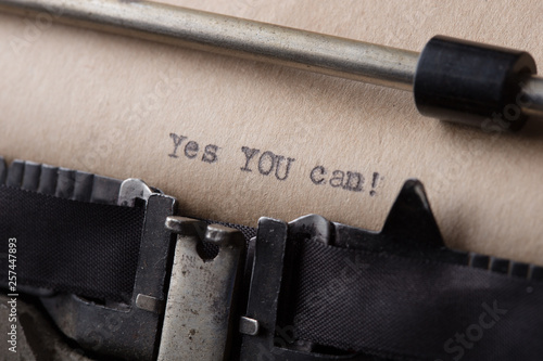 Yes you can - motivational slogan in vintage letterpress wood type on a digital tablet with a cup of coffee