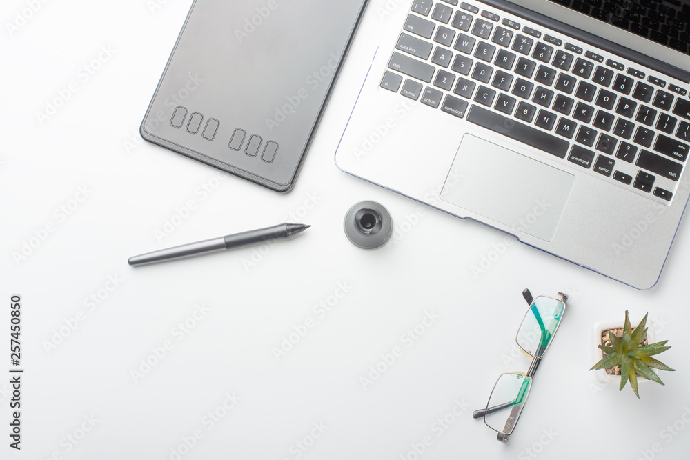 Desktop designer and creative retoucher with a graphics tablet, laptop, glasses. Design, flat lay Desktop designer and creative retoucher with a graphics tablet, laptop, glasses. Design, flat lay