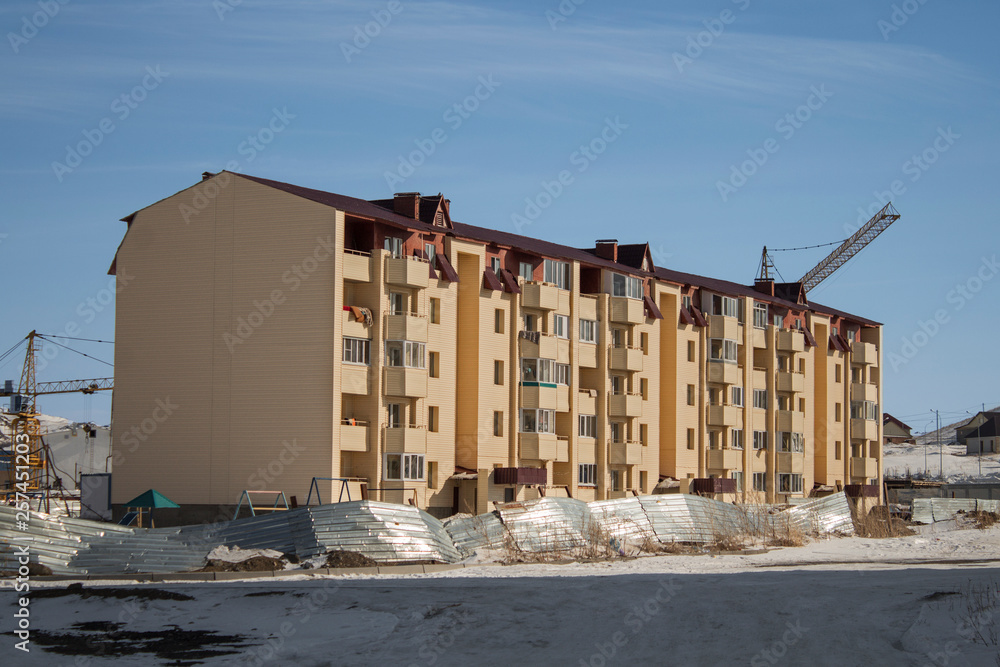 Obraz premium Newly built residential building. Ust-Kamenogorsk (Kazakhstan). Modern architecture. New residential area. Construction cranes