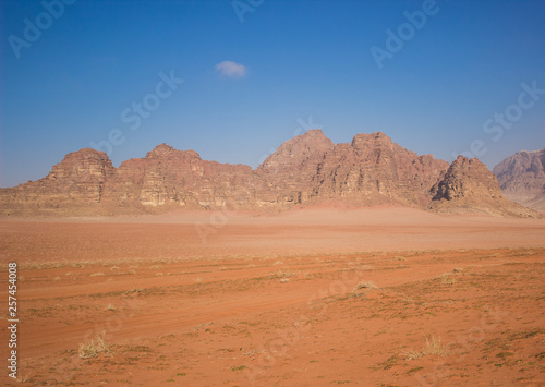 Wadi Rum Muddle East desert scenery landscape in Jordan country with sand valley foreground and panorama bare mountain ridge background  travel and touristic concept photography pattern 