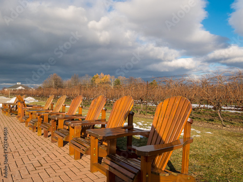 empty wooden chairs at vineyard photo