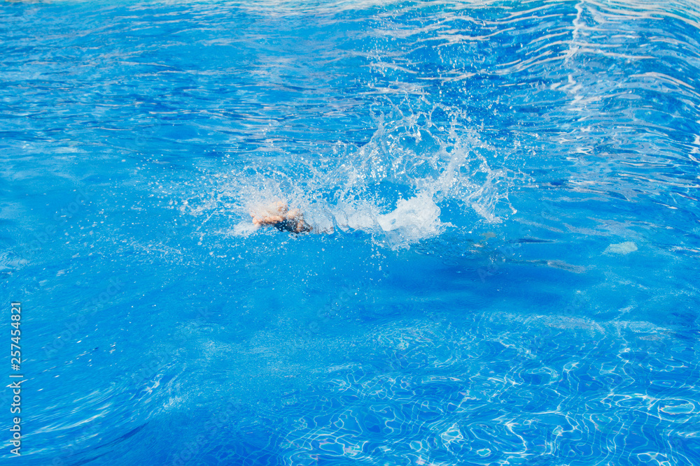 Naklejka premium a man jumps into the pool. Swimmer in the water
