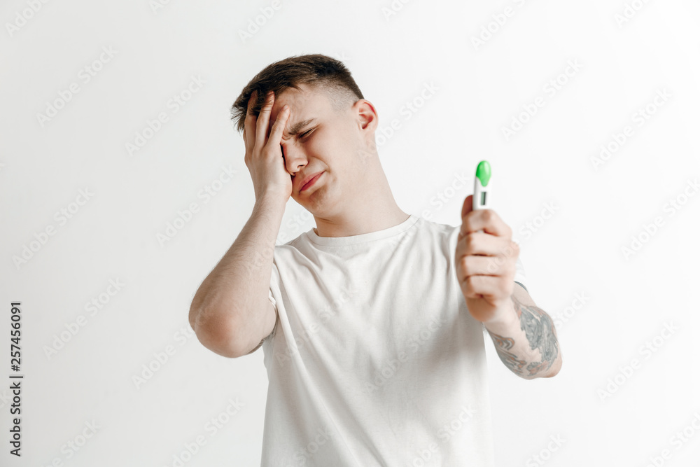 Upset man looking in pregnancy test. Human emotions concept Upset man looking in pregnancy test. Human emotions concept