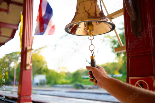 Hand rings the bell. Male hand is ringing the bell. photo