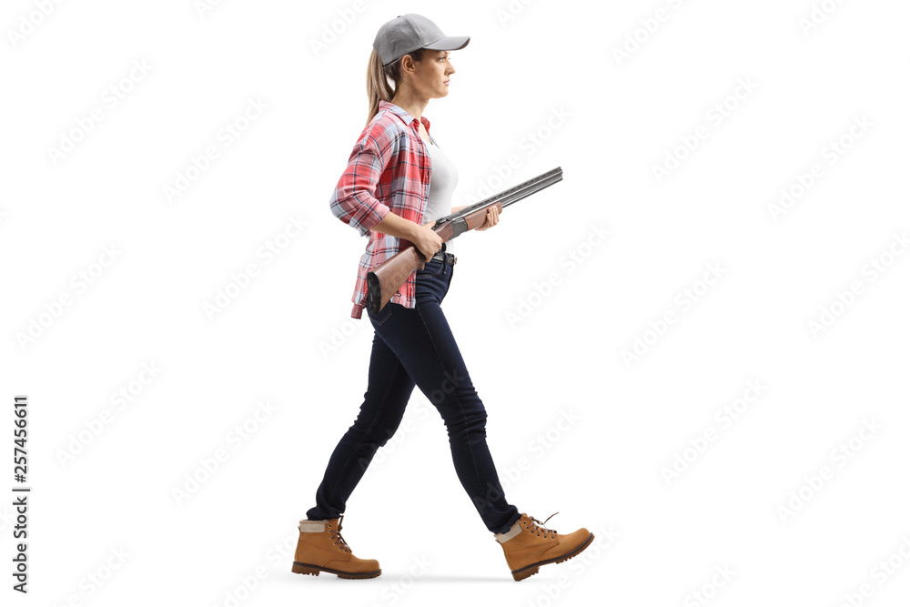 Female walking with a shotgun