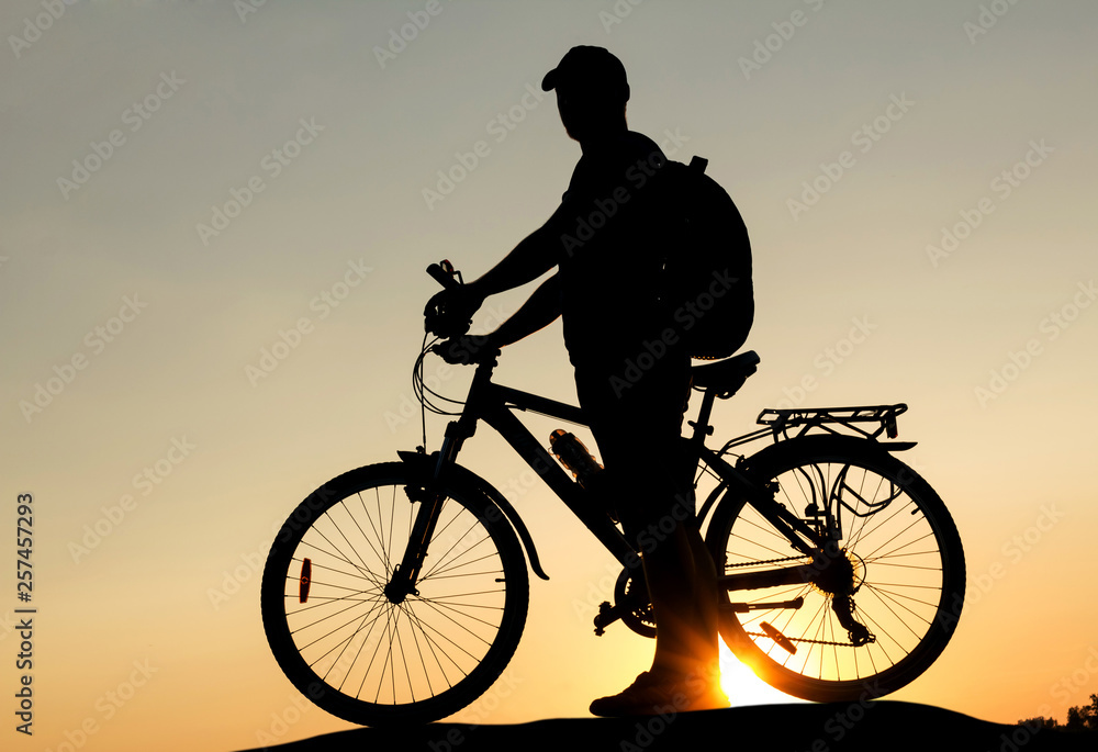 Obraz premium Concept of healthy lifestyle. Silhouette of cyclists at sunset