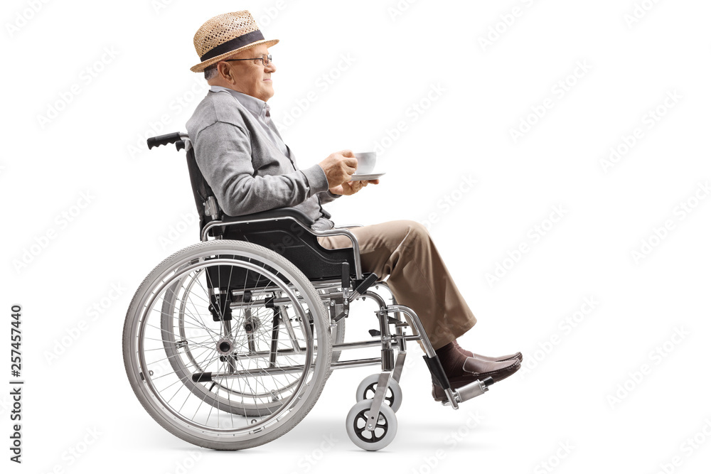 Elderly man sitting in a wheelchair with a cup of coffee Elderly man sitting in a wheelchair with a cup of coffee