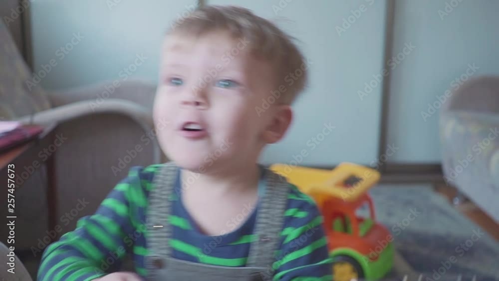 cheerful little boy is playing guitar singing and dancing cheerful little boy is playing guitar singing and dancing