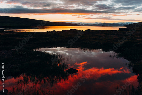 Red sunset on the shore of the lake.