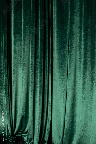 Green curtain of luxurious velvet on the theater stage. Copy space. The concept of music and theatrical art. Concept for a festive performance for St. Patrick's Day, festival, jazz month photo
