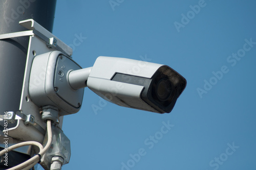 closeup of security camera on blue sky background