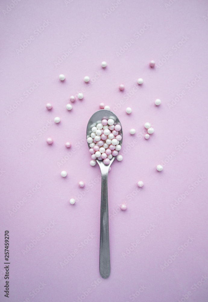 Stainless steel spoon with small pink and white balls Stainless steel spoon with small pink and white balls