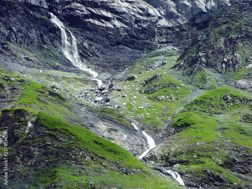 Nameless waterfalls under the Alpine peaks Glarner Vorab and Bünder Vorab in the valley of Im Loch - Canton of Glarus, Switzerland photo