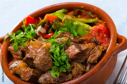 Cooked gyuvech dish of bulgarian cuisine of beef  with vegetables at clay pot
