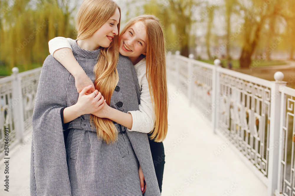 Fototapeta premium two pretty sisters in a park
