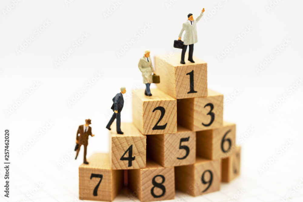 Miniature people: Business people standing on wooden box with top of ranking. Business career growth,  achievement, success., victory or top ranking Concept.