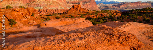 Sunset during golden hour in Southern Utah, sun warming red sandstone, cliffs, mountains, and mesa © JMP Traveler