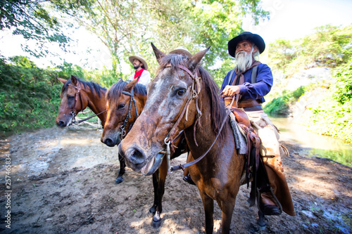 cowboy and horse at first light,mountain, river and lifestyle with natural light background