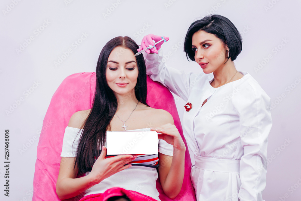Doctor and young woman holding box with empty space you can place you text or logo Doctor and young woman holding box with empty space you can place you text or logo