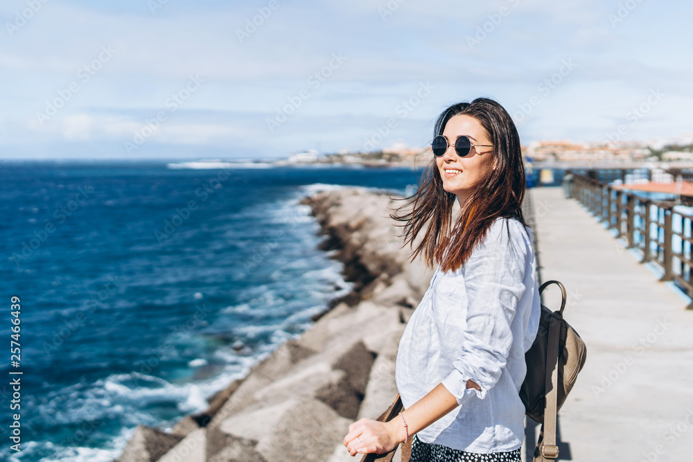 Pretty long hair brunette girl relaxing near ocean. Pretty long hair brunette girl relaxing near ocean.