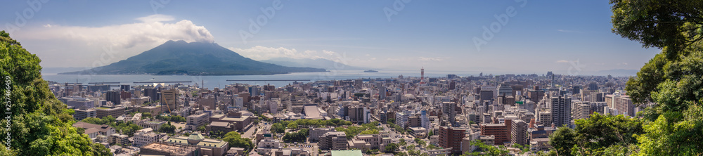 Panorama of Kagoshima City with erupted Vulcan Sakurajima and Kagoshima Bay on a clear summer day. Located in Kagoshima, Kyushu, South of Japan.