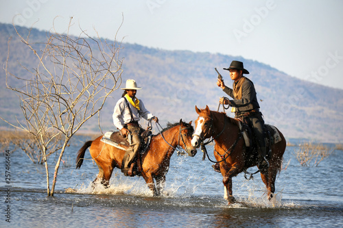 cowboy and horse  at first light,mountain, river and lifestyle with natural light background © FotoArtist