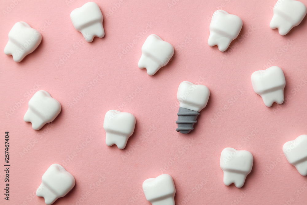 Healthy white teeth and implants on pink background Healthy white teeth and implants on pink background