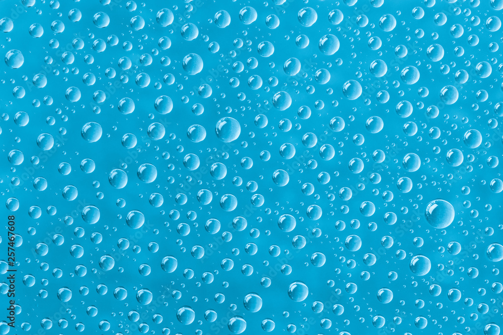 Beautiful water drops of the correct form on a gentle  turquoise background