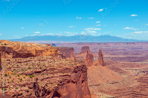 Canyon and Washer Woman Arch near Mesa Arch in Canyonlands National Park with La Sal Mountains at the background, Moab, Utah, USA.