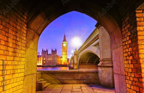 View of the Houses of Parliament from the bottom of Westminster Bridge in London at night.