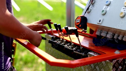 Pillar driving of hydraulic drilling or hammer machines on construction site. Worker operate pillars machine. Building solar power station.