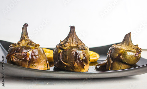 traditional cuisine: artichokes cooked in the oven with oil and lemon photo