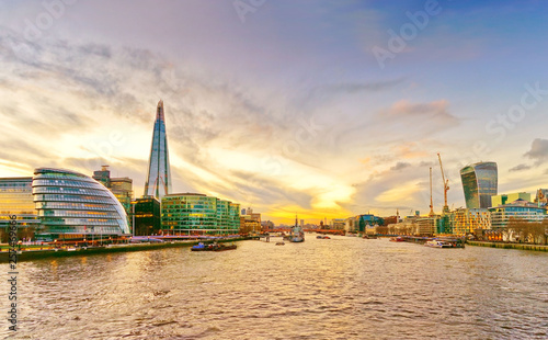 Panorama of London skyline and River Thames at sunset.
