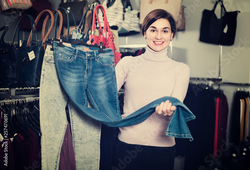 Female shopper boasting her purchases in women’s cloths shop