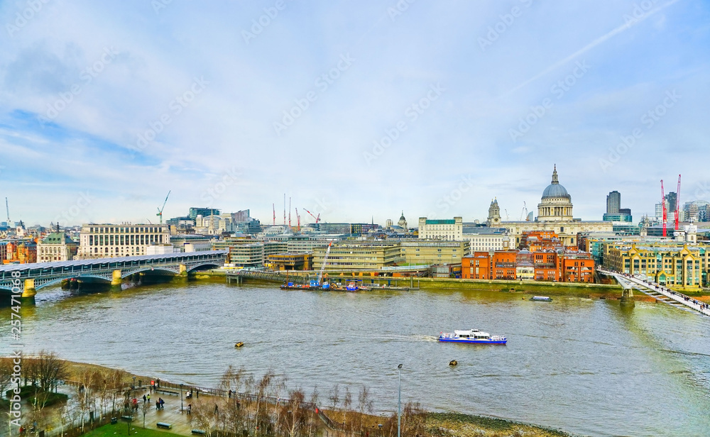 View of London skyline with River Thames on a cloudy day.