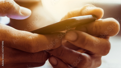 Wallpaper Mural Closeup Image of man's hand holding a smartphone Torontodigital.ca