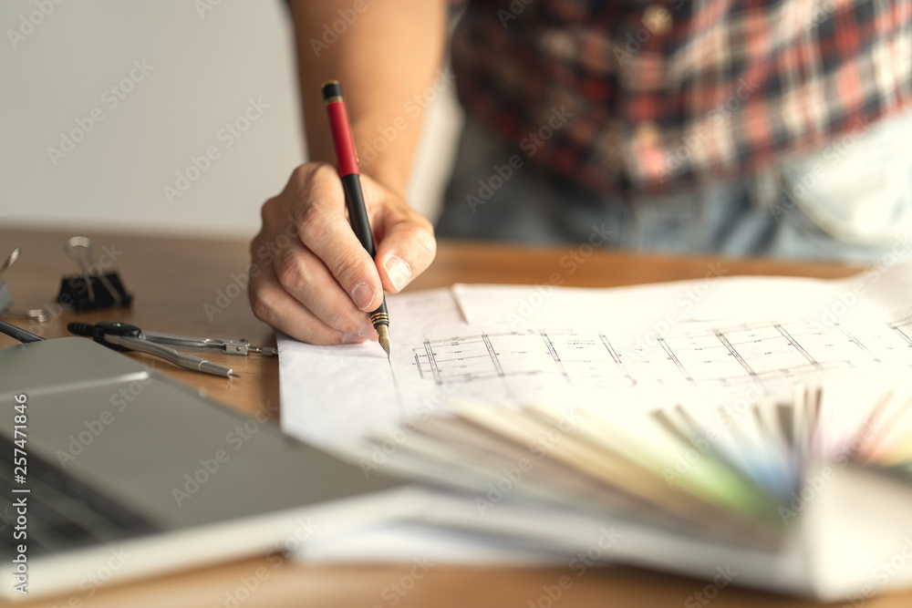 Architect & Engineer working drawing document about project planning and progress of work schedule on the home building construction site Architect & Engineer working drawing document about project planning and progress of work schedule on the home building construction site
