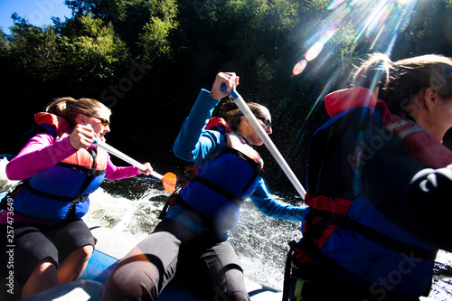 A group of adults navigate the Kennebec River in West Forks, Maine during a whitewater rafting trip on September 11, 2010.  This day water flow was 8,000 cubic feet per second, which is almost twice the normal amount of water flow. photo