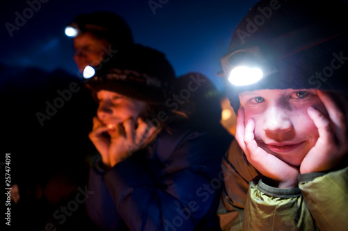 Jim Zellers and his two sons Dylan and Ryan talk and laugh by the campfire at night in the backcountry of California. photo