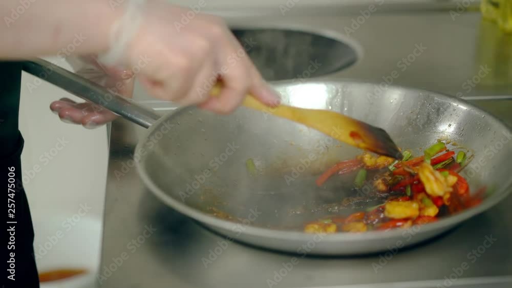 Cook roasted shrimps with vegetables in frying pan wok, watered them with sauce. Cook roasted shrimps with vegetables in frying pan wok, watered them with sauce.