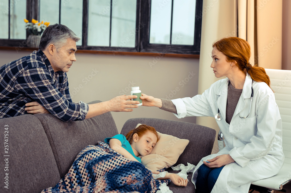Nice good looking man taking a bottle with pills Nice good looking man taking a bottle with pills