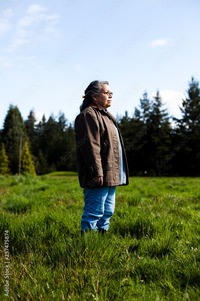 A portrait of a woman in a field on a sunny day. A portrait of a woman in a field on a sunny day.
