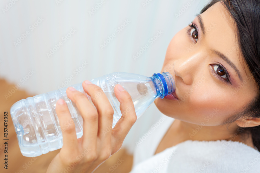 Asian Chinese Girl Drinking Bottle of Water at Gym Asian Chinese Girl Drinking Bottle of Water at Gym