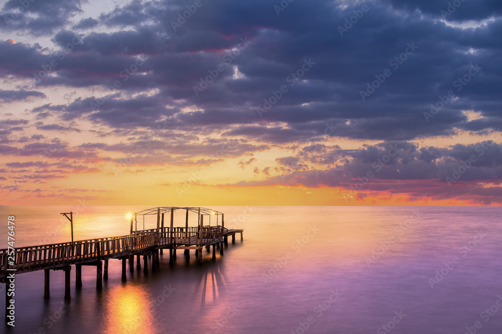 Wood bridge with seascape at twilight time, Chonburi beach, famous attraction of Thailand.
