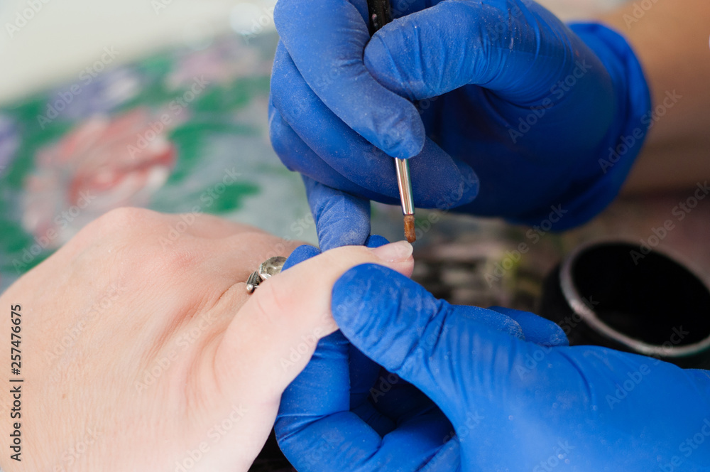 Manicure, extension and cleaning of nails in a beauty salon. Beauty services concept Manicure, extension and cleaning of nails in a beauty salon. Beauty services concept