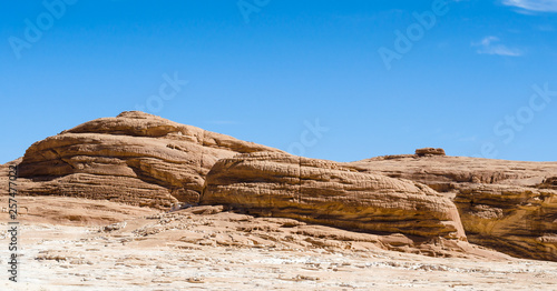 high rocky mountains against the blue sky and white clouds in the desert in Egypt Dahab South Sinai